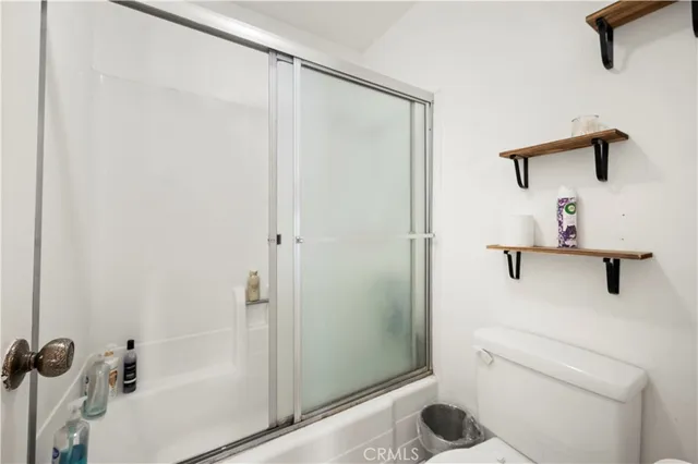 a bathroom with a shower and toilet