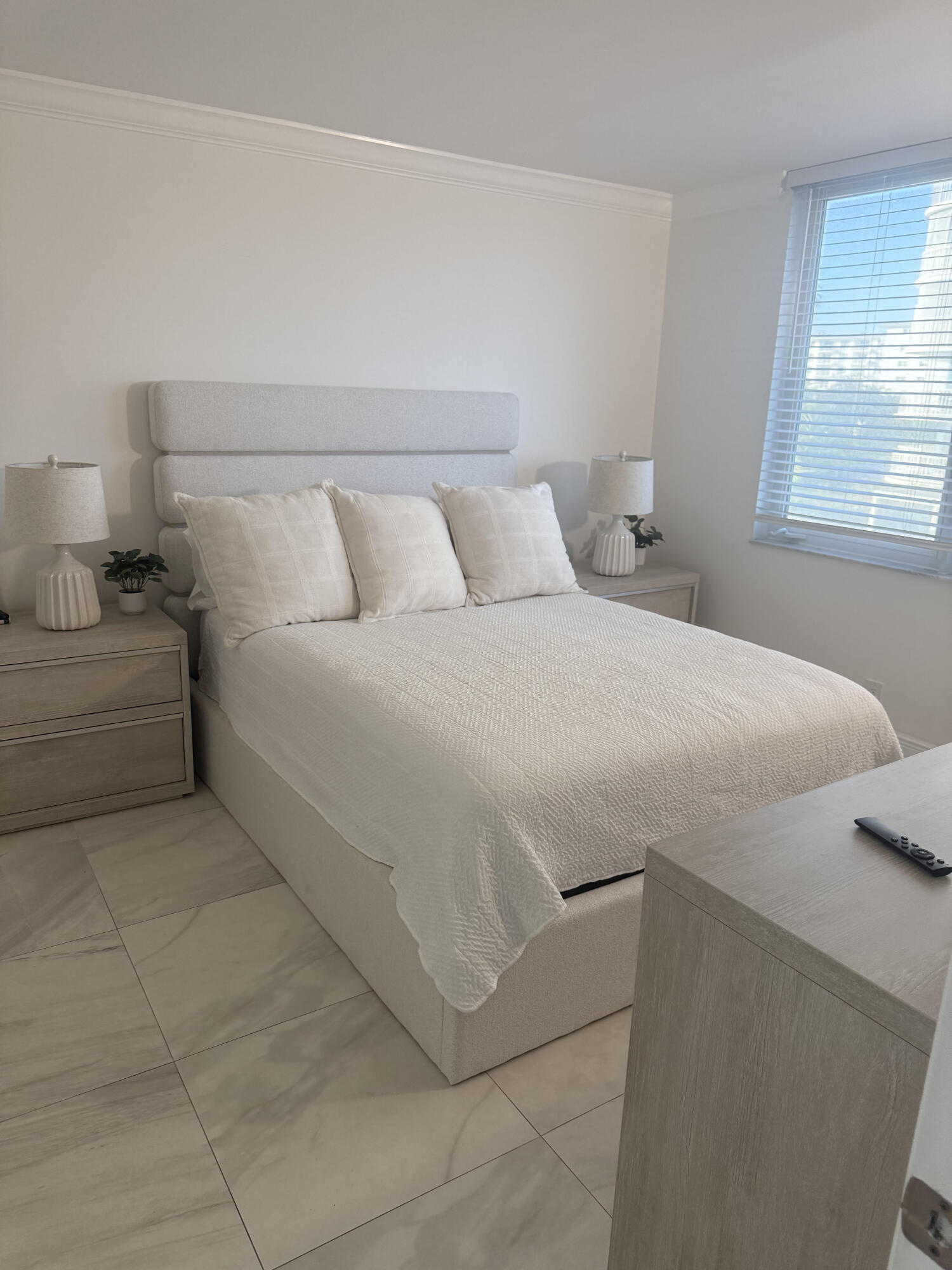 3215 South Ocean Boulevard, Unit 210 Highland Beach, FL 33487 - Photo 2 of 9 a bedroom with a bed and a window