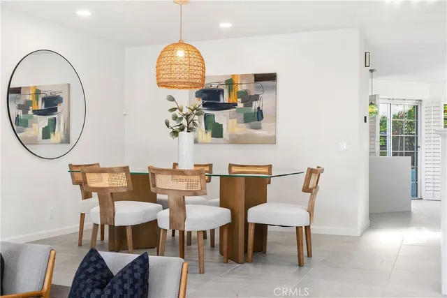 a view of a dining room with furniture and a mirror