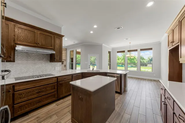 a kitchen with a sink stove and cabinets