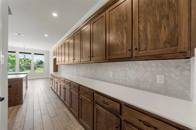 a kitchen with wooden cabinets and sink