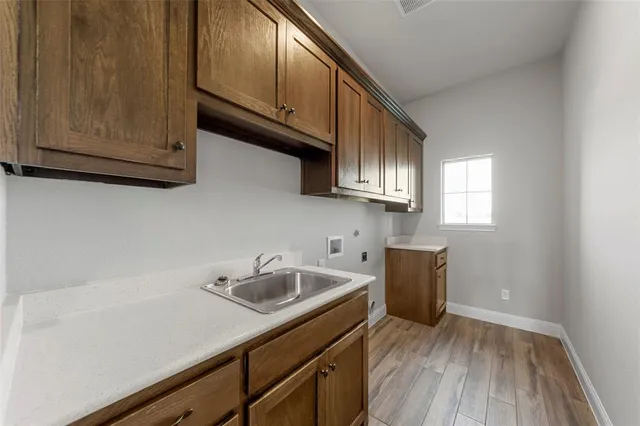 a kitchen with sink and cabinets