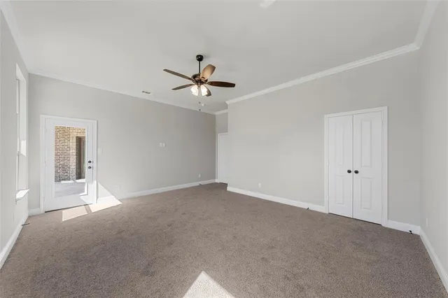 a view of an empty room with a ceiling fan