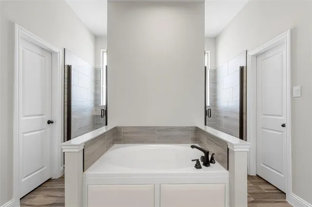 a bathroom with a tub and shower