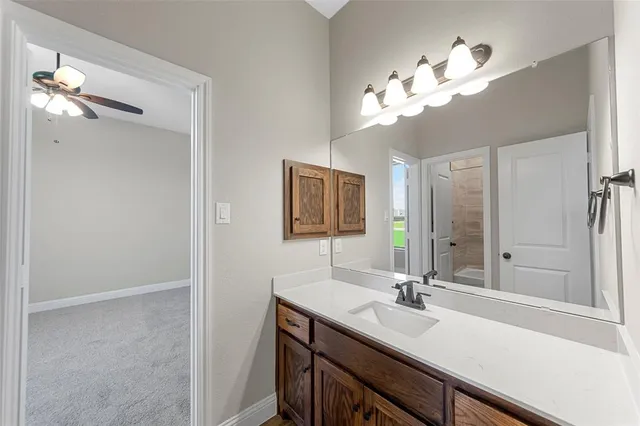 a bathroom with a sink a light fixture and a mirror