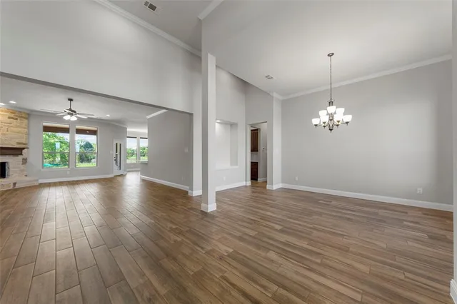 a view of a room with wooden floor and chandelier