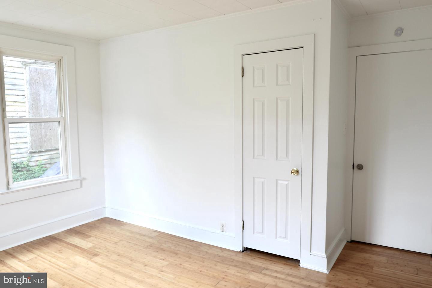 149 South Main Street, Unit 1 Elmer, NJ 08318 - Photo 11 of 14 an empty room with wooden floor and windows