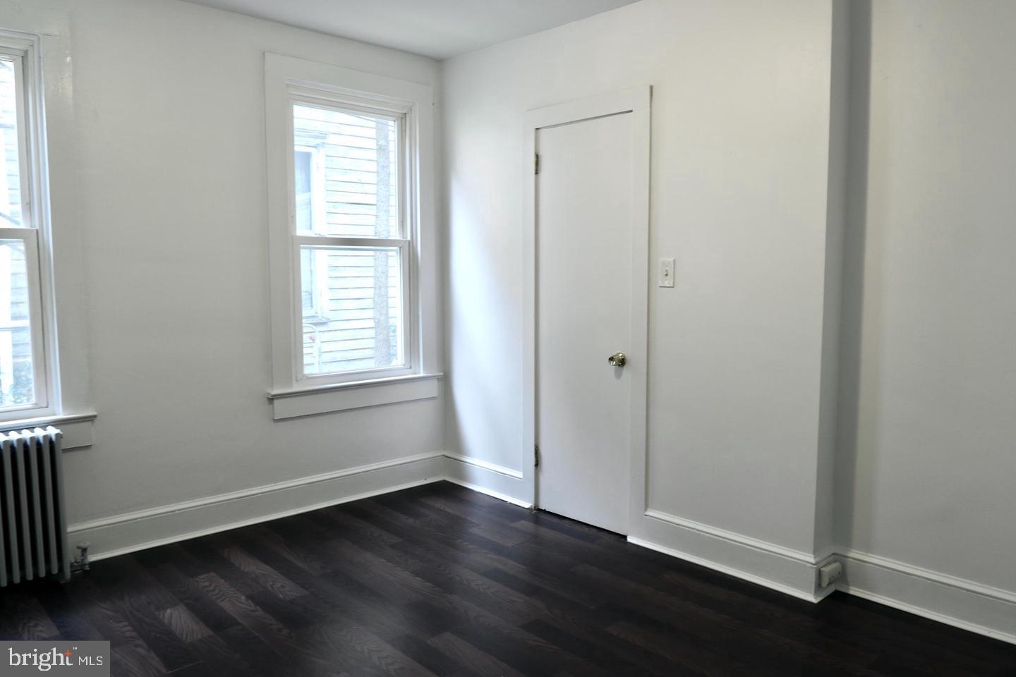 149 South Main Street, Unit 1 Elmer, NJ 08318 - Photo 13 of 14 an empty room with wooden floor and windows