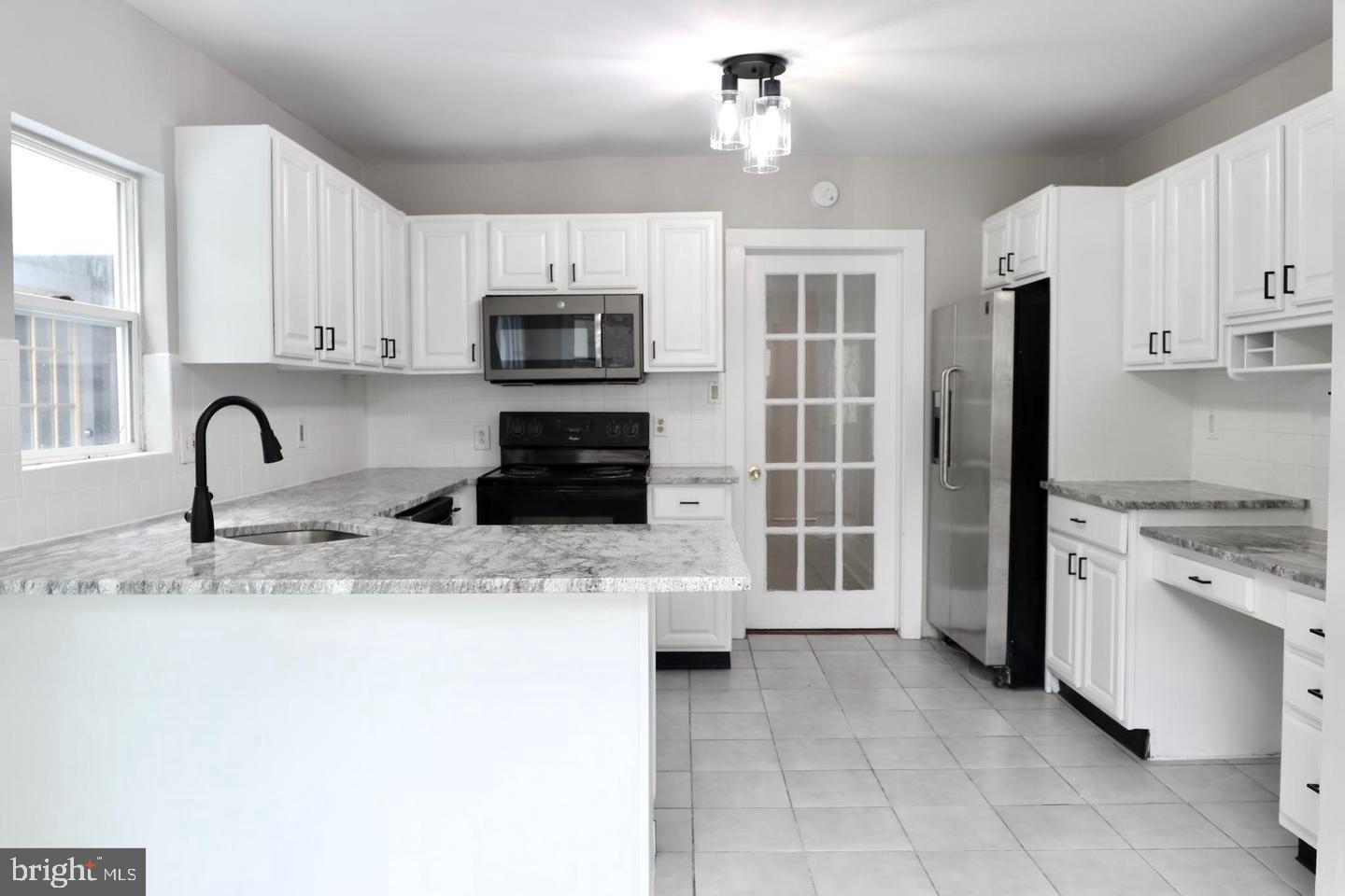 149 South Main Street, Unit 1 Elmer, NJ 08318 - Photo 2 of 14 a kitchen with stainless steel appliances granite countertop a stove a sink and a refrigerator