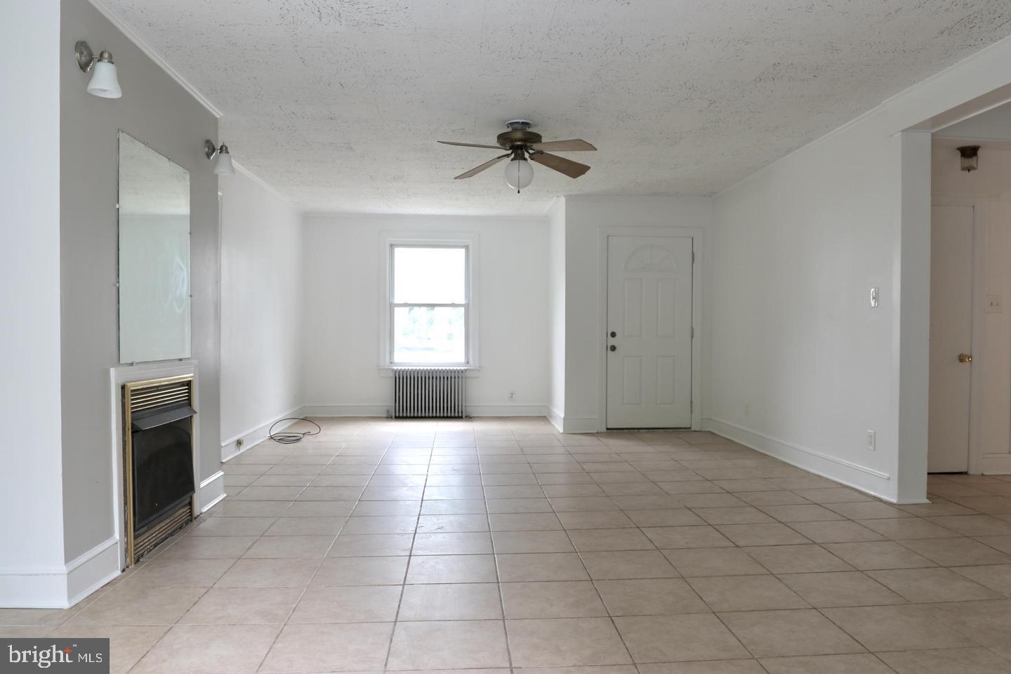 149 South Main Street, Unit 1 Elmer, NJ 08318 - Photo 8 of 14 a view of an empty room with a fireplace and a window