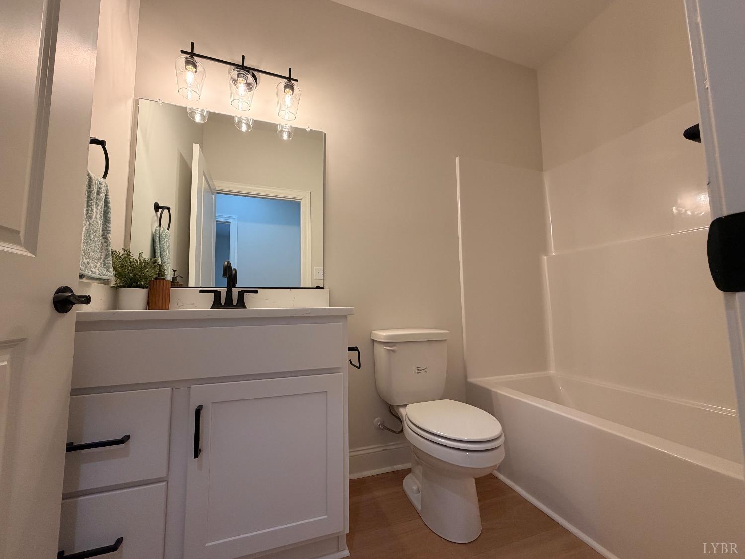 536 Leesville Road, Unit 207 Lynchburg, VA 24502 - Photo 14 of 35 a bathroom with a toilet a sink and a mirror