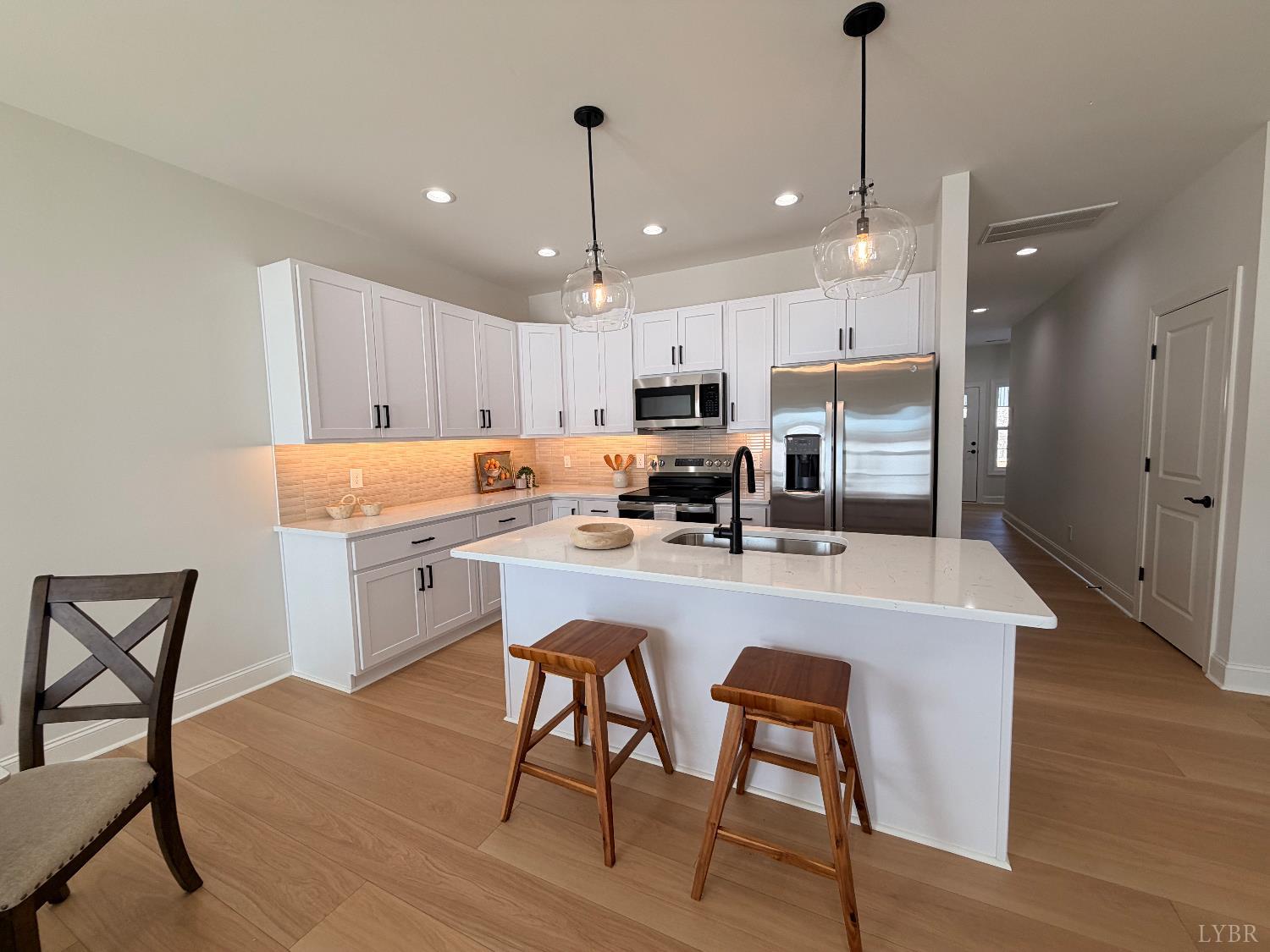 536 Leesville Road, Unit 207 Lynchburg, VA 24502 - Photo 2 of 35 a kitchen with a table chairs refrigerator and microwave