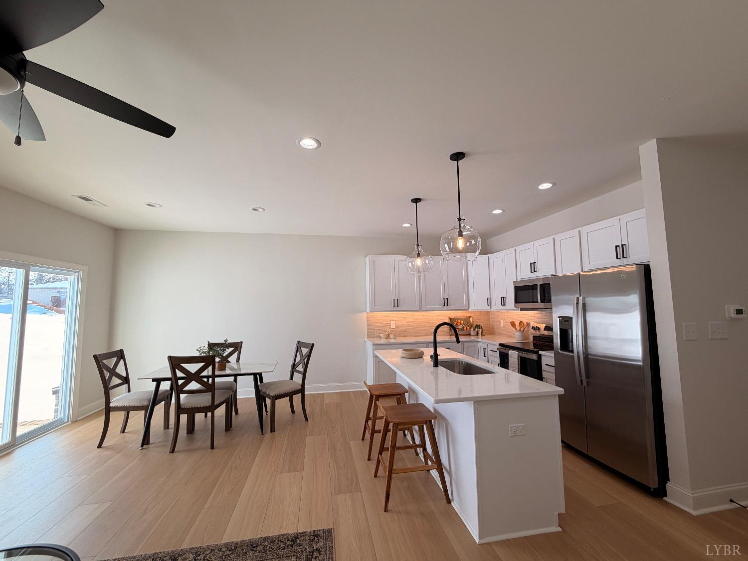 536 Leesville Road, Unit 207 Lynchburg, VA 24502 - Photo 7 of 35 a kitchen with kitchen island a dining table chairs stainless steel appliances and cabinets