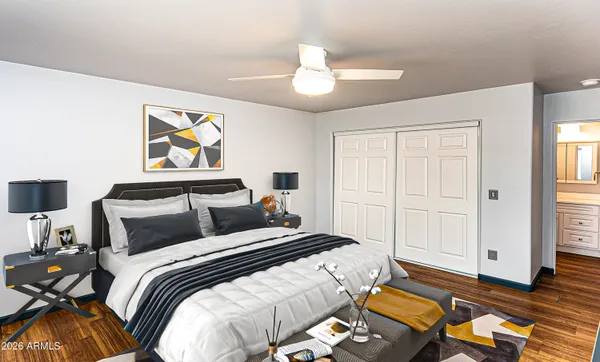 a bedroom with a bed and wooden floor