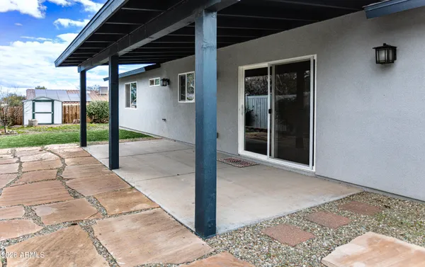 an open kitchen with a table chairs refrigerator and a wooden floor