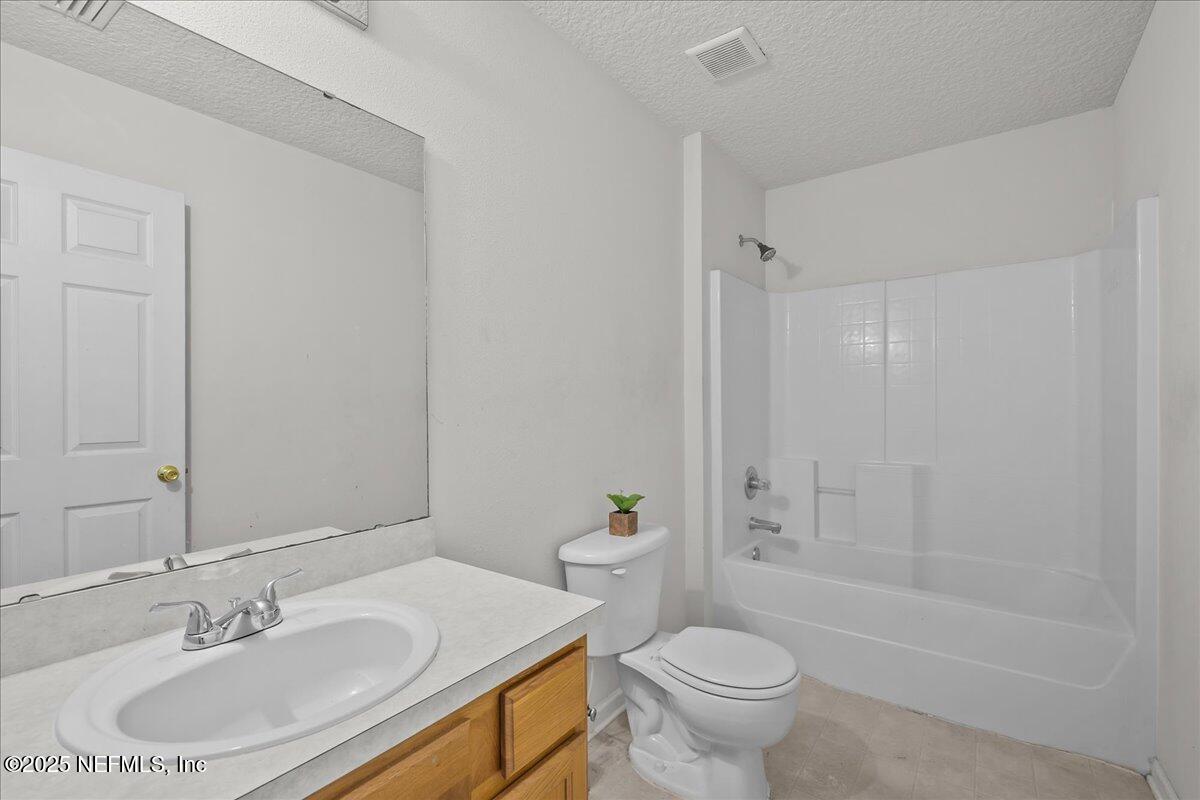 3131 Garden Brook Road Jacksonville, FL 32208 - Photo 18 of 31 a bathroom with a sink toilet and shower