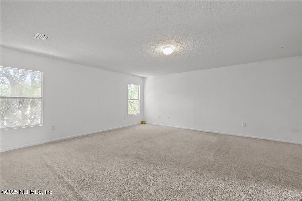 3131 Garden Brook Road Jacksonville, FL 32208 - Photo 19 of 31 an empty room with windows