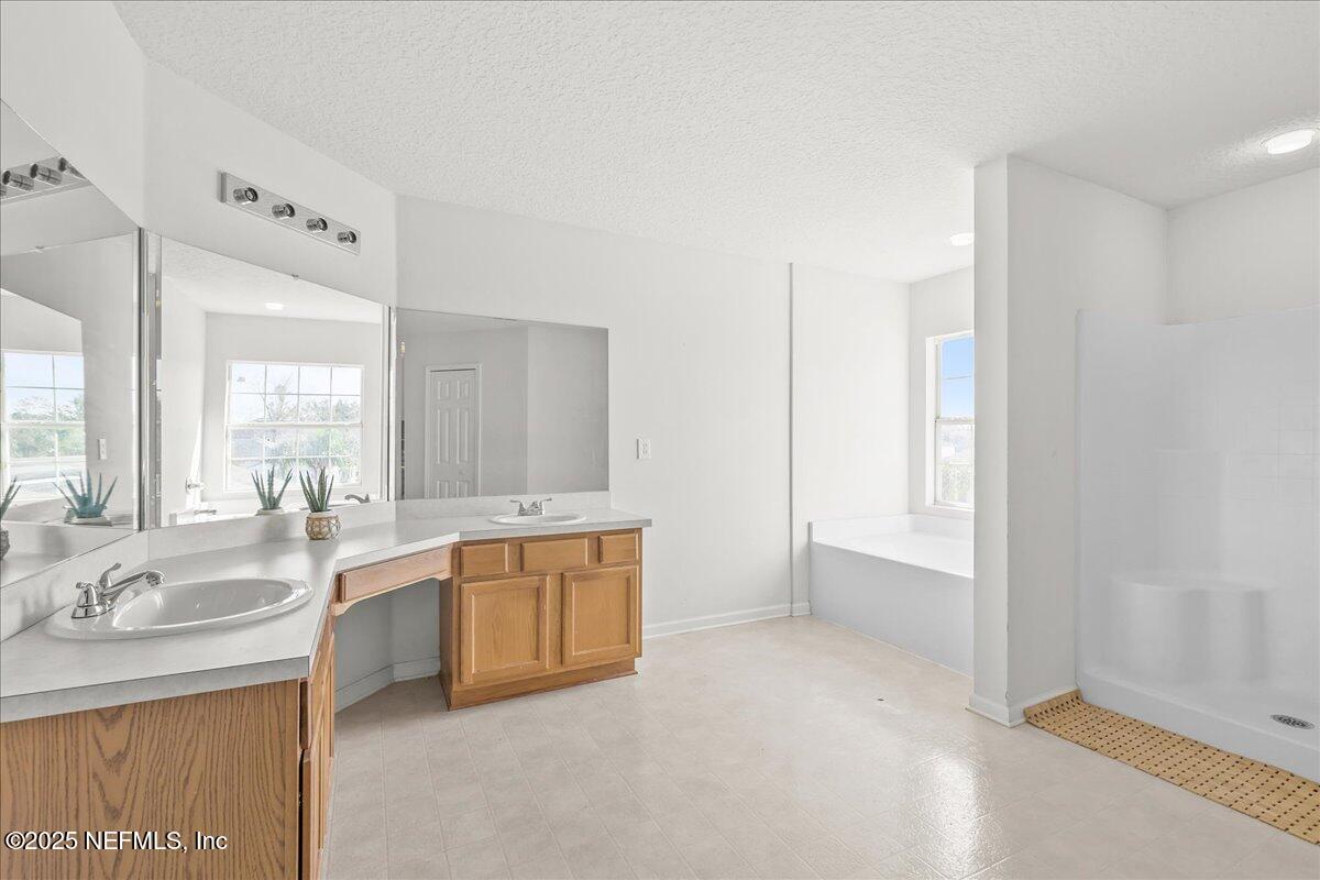 3131 Garden Brook Road Jacksonville, FL 32208 - Photo 21 of 31 a large white kitchen with a sink and dishwasher with a large window