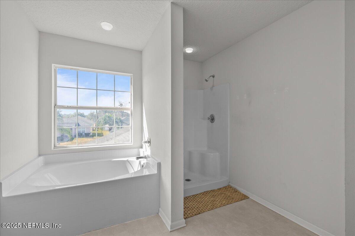 3131 Garden Brook Road Jacksonville, FL 32208 - Photo 22 of 31 a bathroom with a bathtub and window