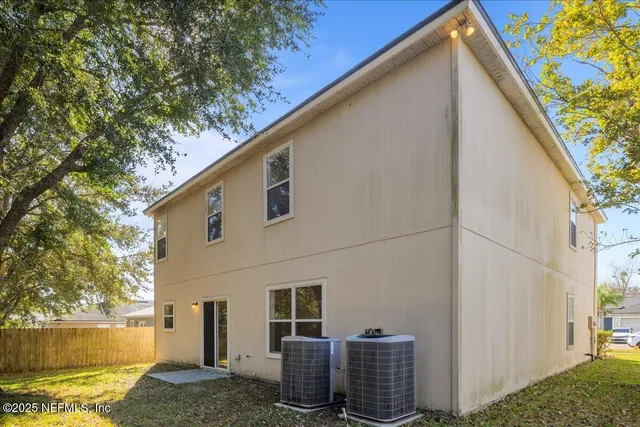 a backyard of a house with lots of green space and outdoor seating