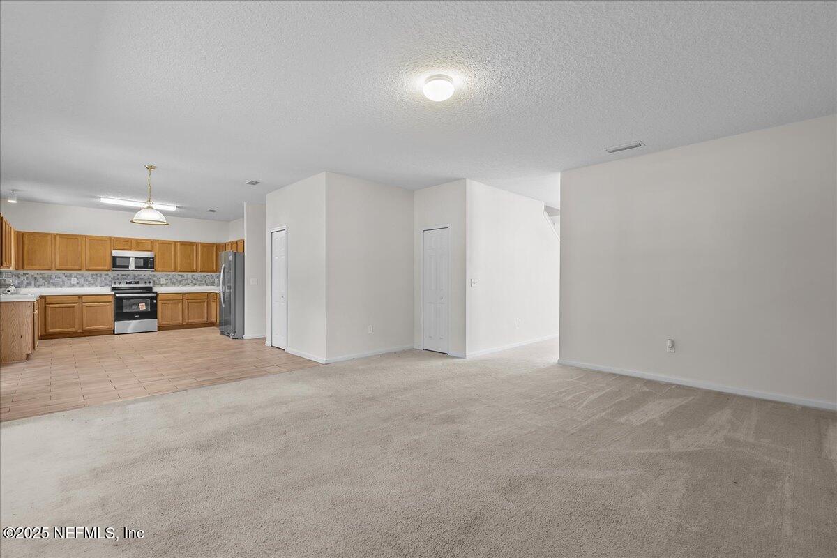 3131 Garden Brook Road Jacksonville, FL 32208 - Photo 7 of 31 a view of an empty room with a kitchen