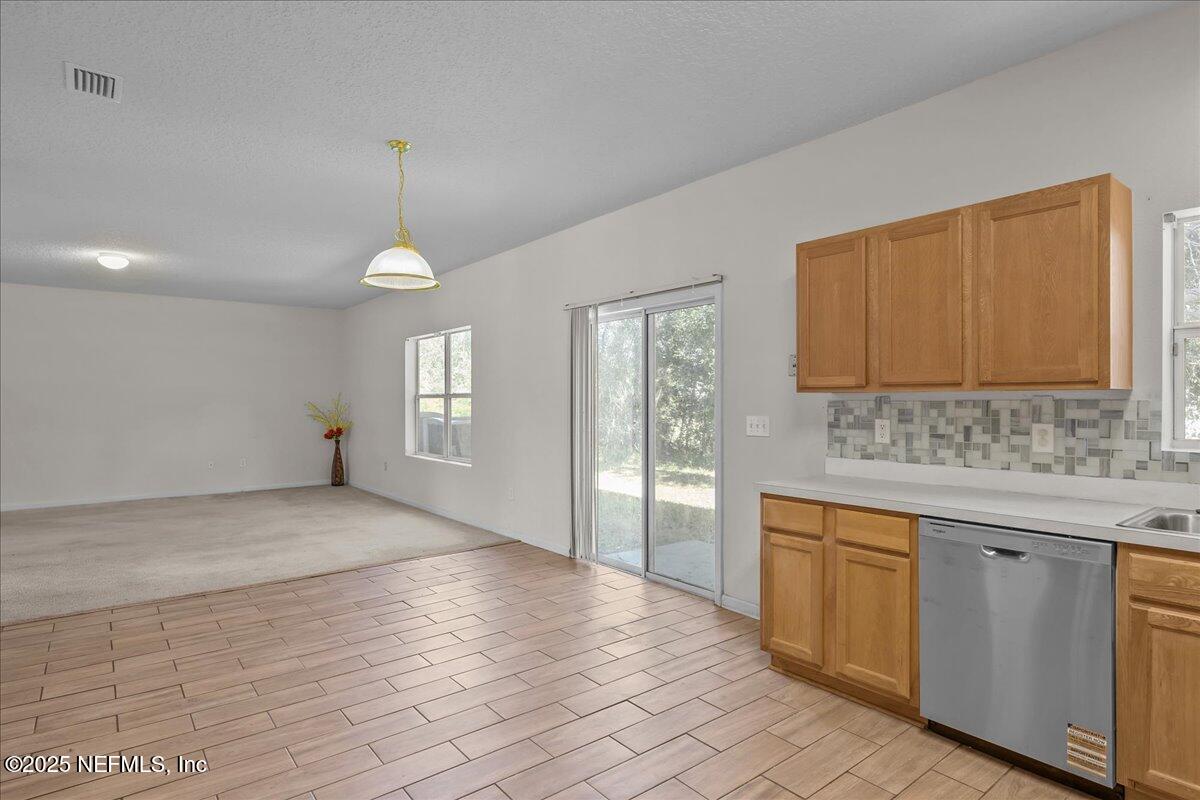 3131 Garden Brook Road Jacksonville, FL 32208 - Photo 10 of 31 a view of a kitchen with wooden floor and electronic appliances