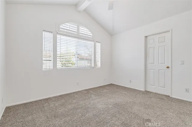 a view of a backyard with wooden fence