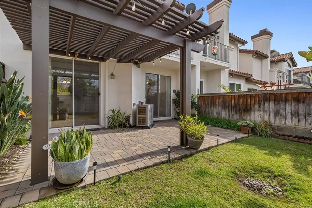 a living room with patio furniture and a potted plant