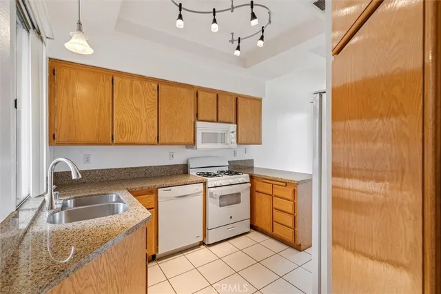 a kitchen with a stove sink and cabinets