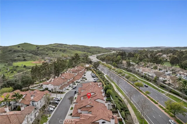 an aerial view of a house with swimming pool and patio