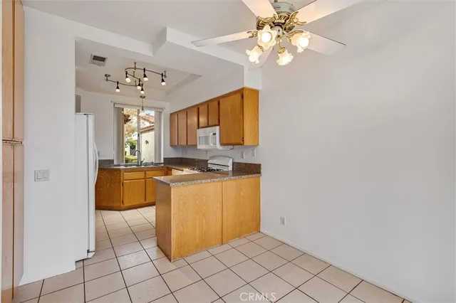 a view of kitchen with kitchen island granite countertop cabinets and window