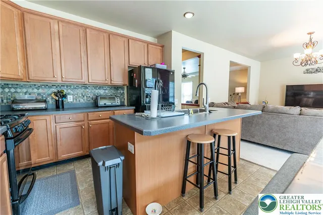 a kitchen with stainless steel appliances granite countertop a sink a stove and cabinets