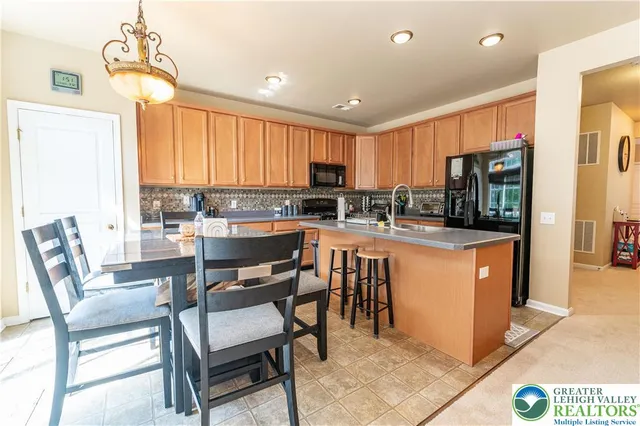 a dining room filled counter top space a sink and a window