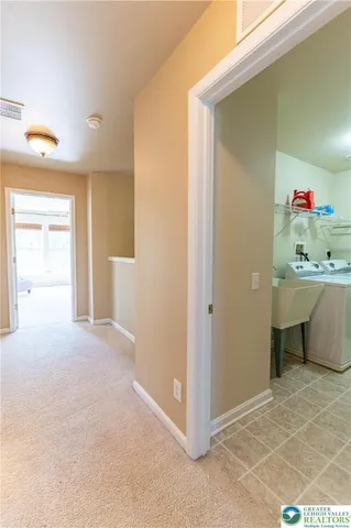 a view of a room that has a bed and a cabinets in it