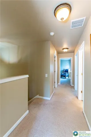 a view of a room with wooden floor and windows