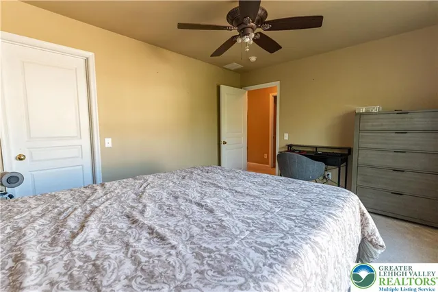 a bedroom with a bed and a chair