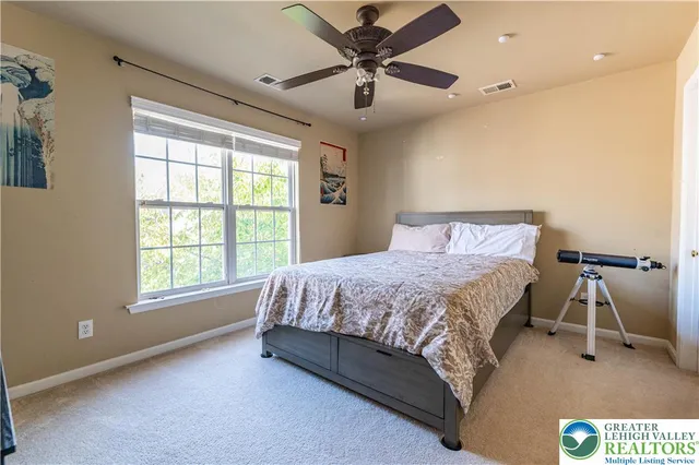 a living room with furniture and a dresser