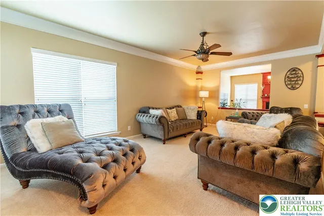 a bedroom with furniture and a large window