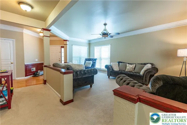 a living room with furniture and a chandelier