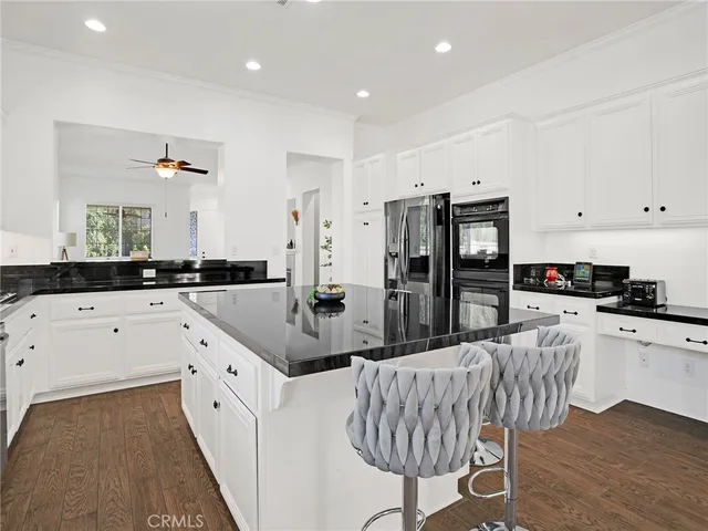 a kitchen with sink stove and cabinets