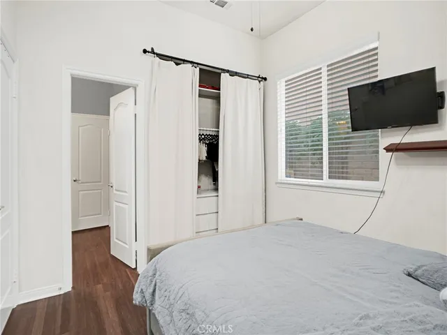 a bedroom with a bed and a desk in it