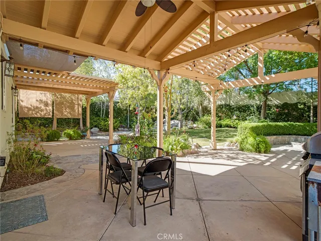 a view of a swimming pool with a patio and a yard