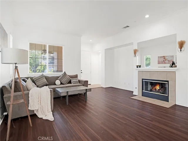 a living room with furniture wooden floor and a fireplace