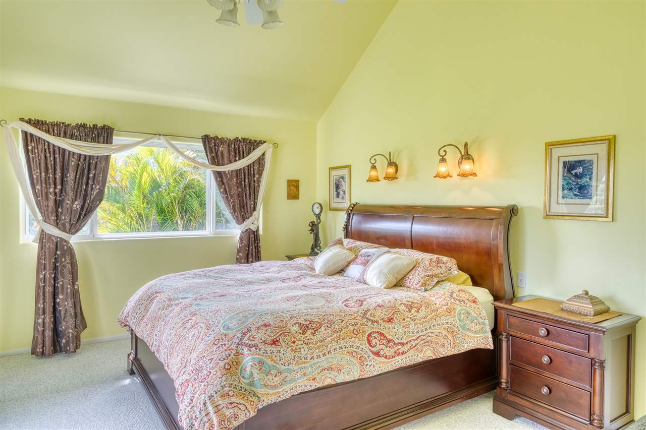 150 Uaoa Loop Haiku, HI 96708 - Photo 13 of 30 a bedroom with a bed a painting on the wall and a window