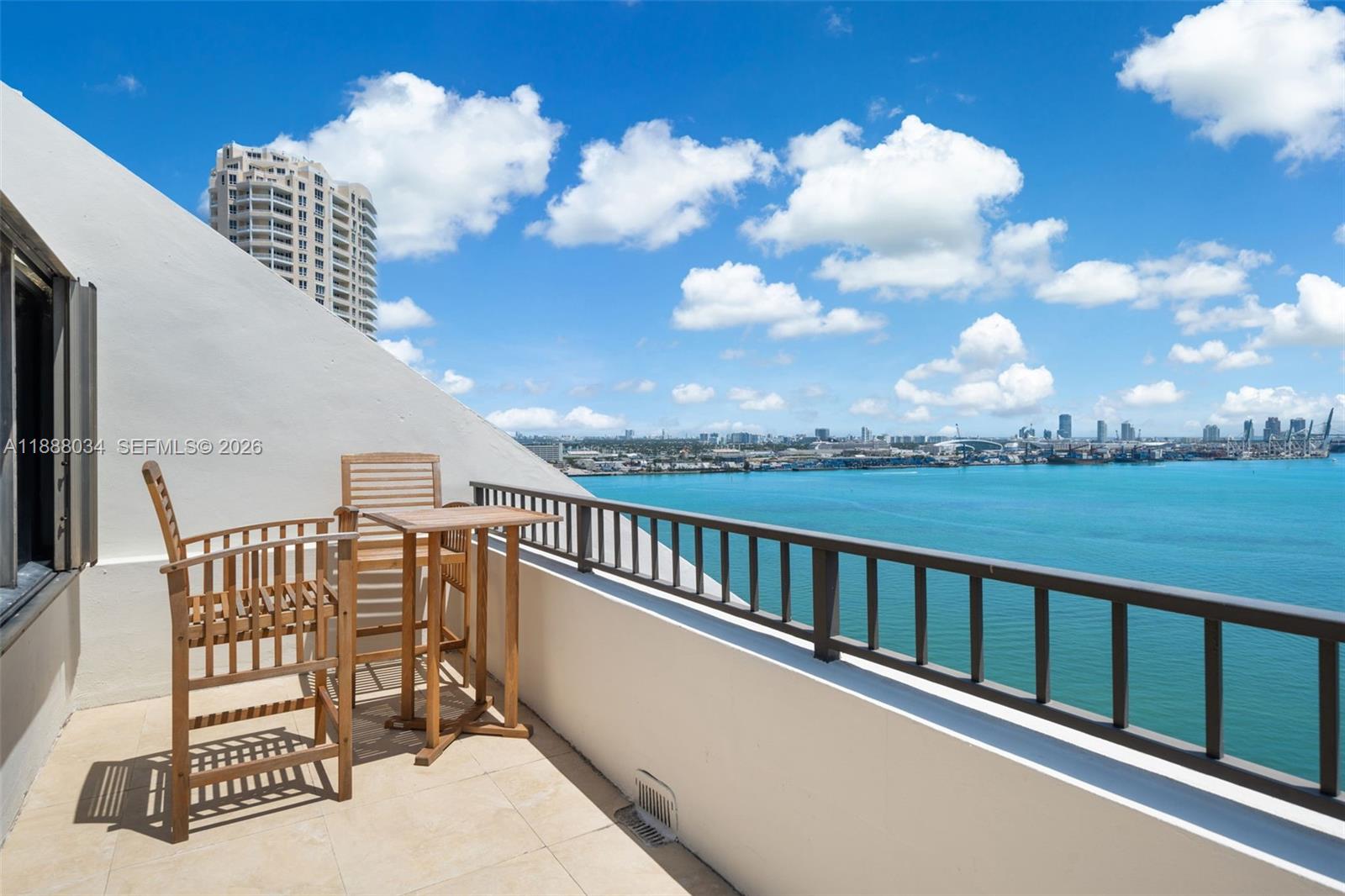 520 Brickell Key Drive, Unit UPH03 Miami, FL 33131 - Photo 12 of 33 a view of a chair and table in the balcony