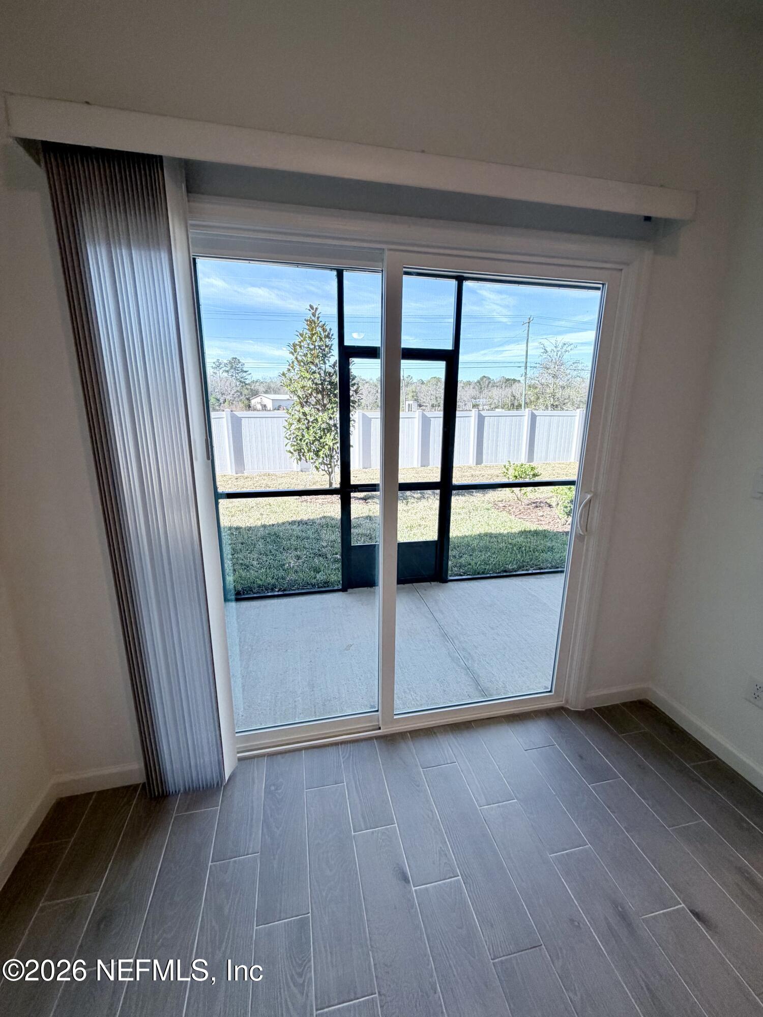 2113 Windward Cay Lane Middleburg, FL 32068 - Photo 11 of 34 an empty room with wooden floor and windows