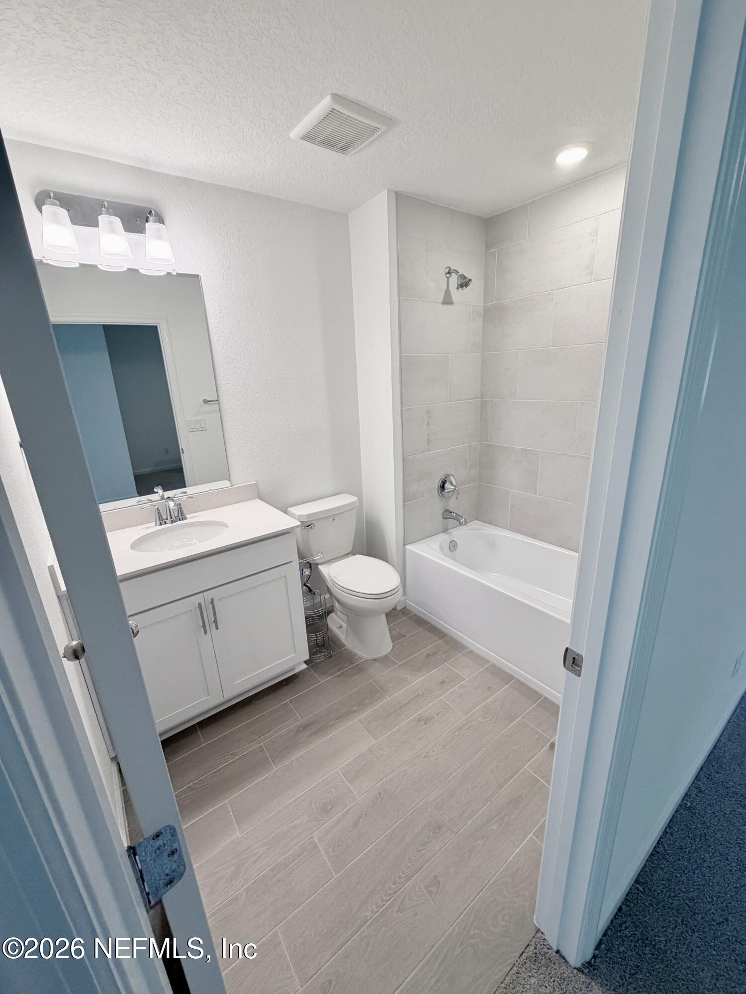 2113 Windward Cay Lane Middleburg, FL 32068 - Photo 22 of 34 a bathroom with a white tub shower vanity and a sink