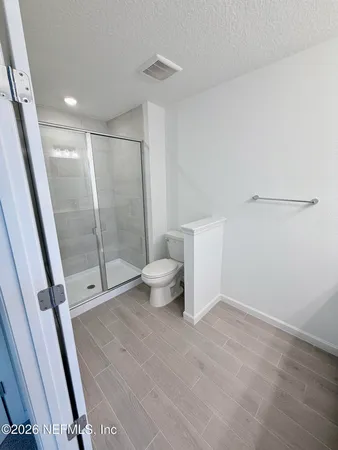 a bathroom with a shower toilet and sink