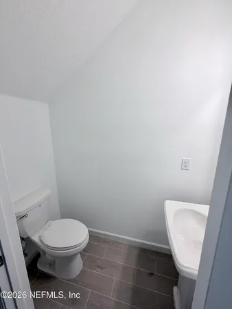 a white toilet sitting next to a white toilet