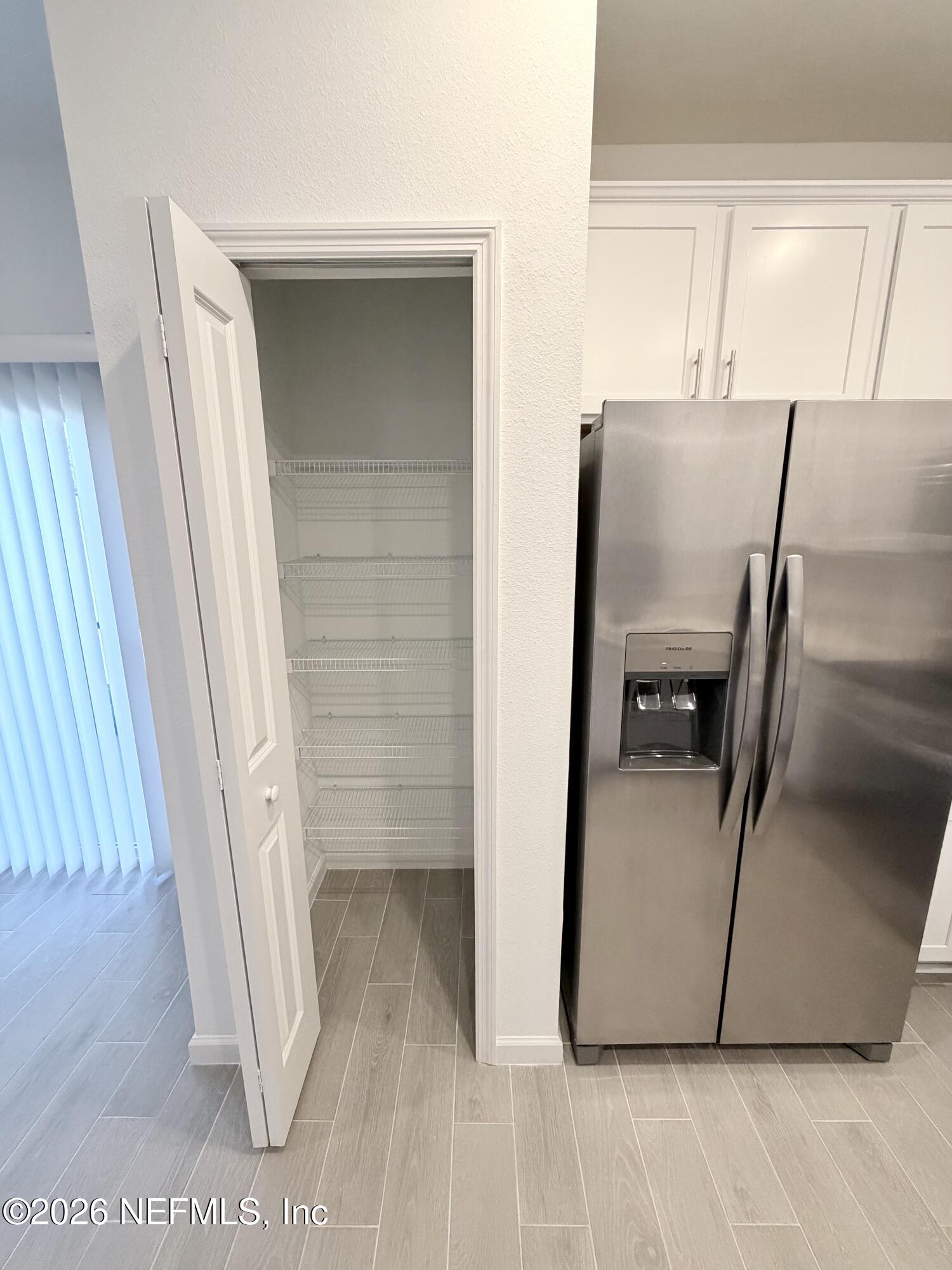 2113 Windward Cay Lane Middleburg, FL 32068 - Photo 10 of 34 a kitchen with a refrigerator and a sink